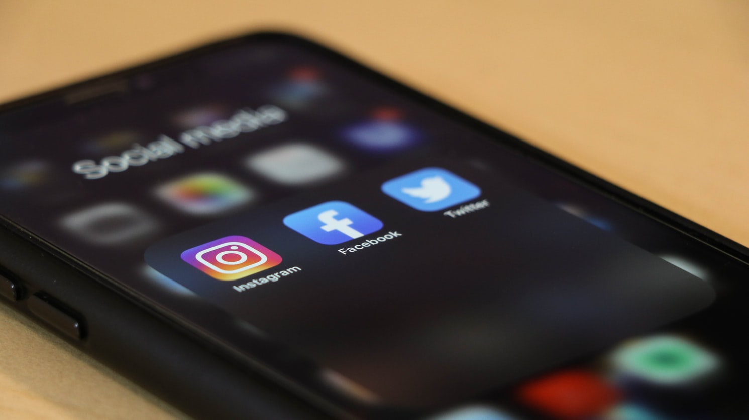 iPhone showing Instagram, Facebook, and Twitter apps