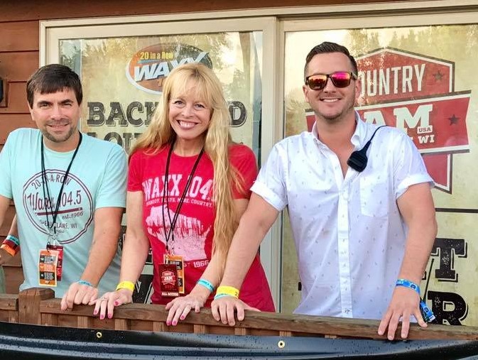 Local radio hosts smiling on outdoor patio