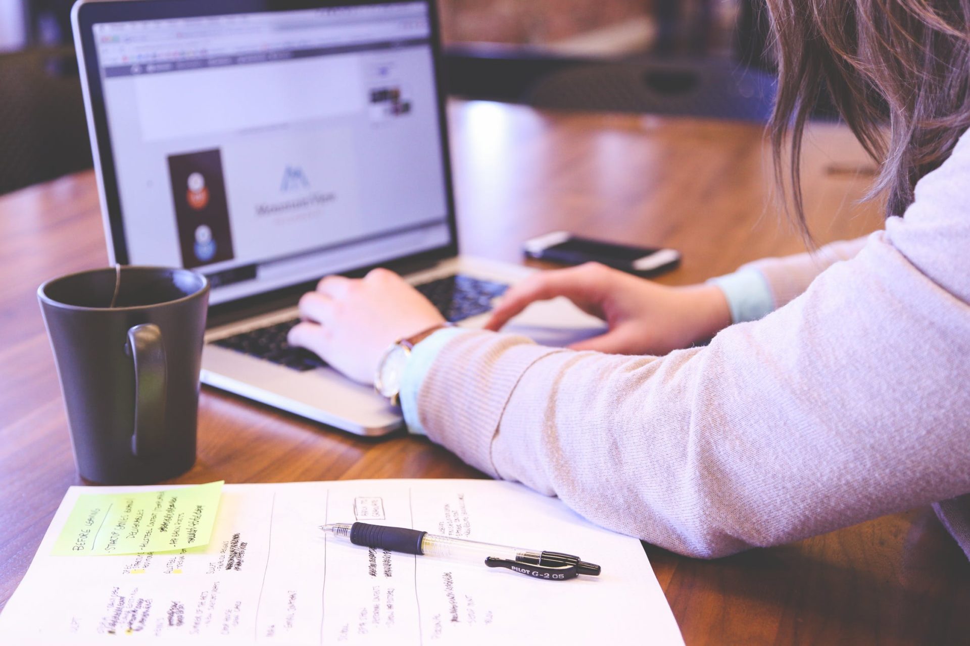 Woman writing content on her laptop